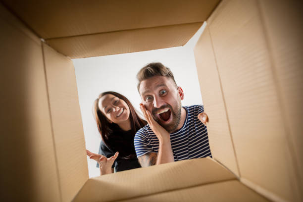 istock The couple unpacking and opening carton box and looking inside 1016721124