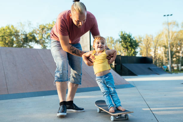 istock Modern dad with three year old son in skate park 1016721156