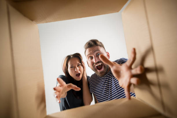 istock The couple unpacking and opening carton box and looking inside 1016721190