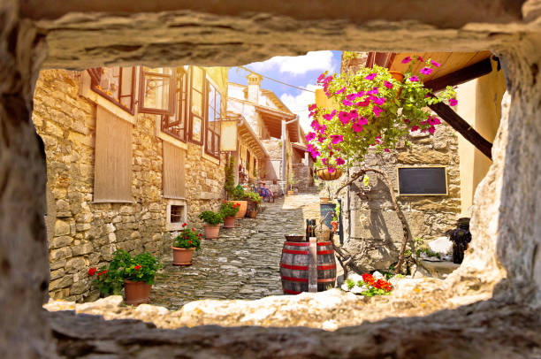Town of Hum colorful old stone street view through stone window, Istria region of Croatia Town of Hum colorful old stone street view through stone window, Istria region of Croatia istria photos stock pictures, royalty-free photos & images