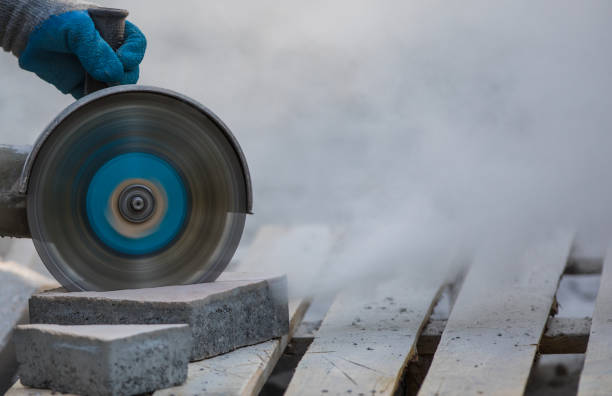 istock grinder worker cuts a stone the electric tool,street construction work 1016723982