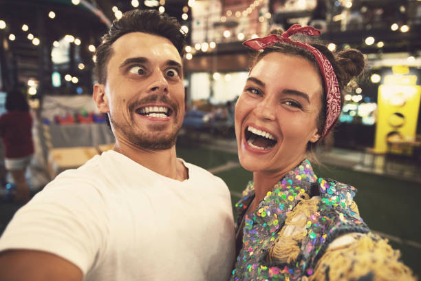 Young couple is making funny faces at evening street