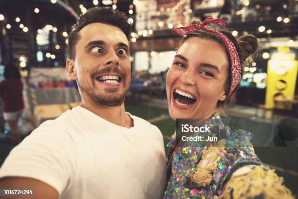 Young Couple Is Making Funny Faces At Evening Street Stock Photo - Download Image Now