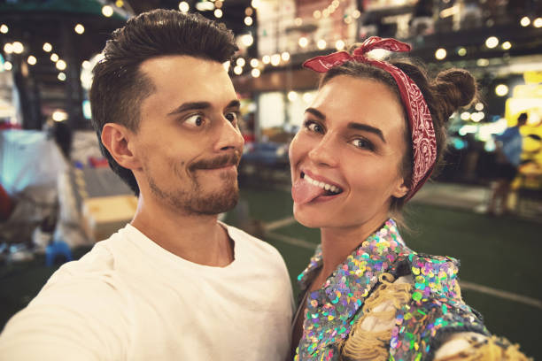 istock Young couple is making funny faces at evening street 1016724306