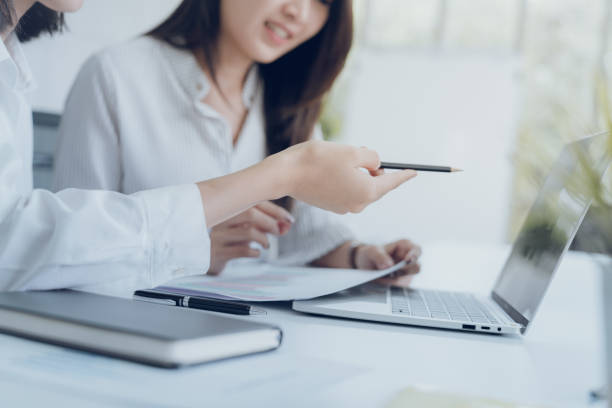 istock Business team during meeting conference are working documents about the marketing plan and finance sales report of the company with laptop computer and smartphone tablet on work table 1016737698