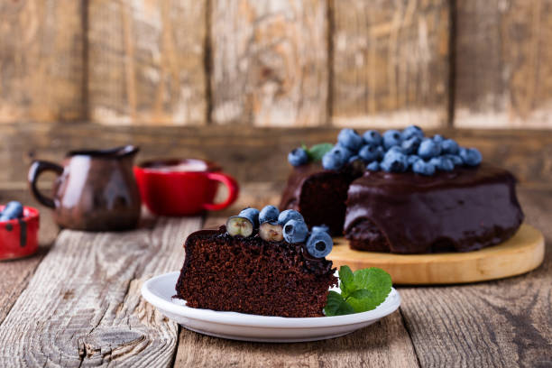 istock Chocolate cake topped with chocolate glaze and fresh blueberries 1016737880