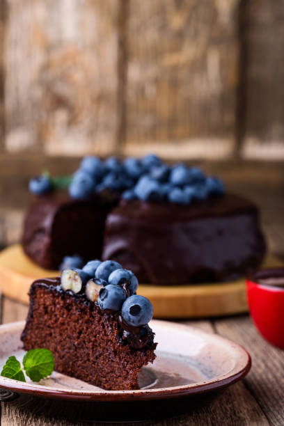istock Chocolate cake topped with chocolate glaze and fresh blueberries 1016737928