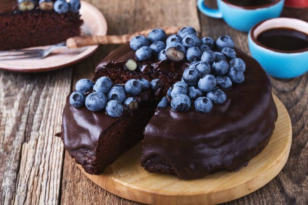 istock Chocolate cake topped with chocolate glaze and fresh blueberries 1016740074