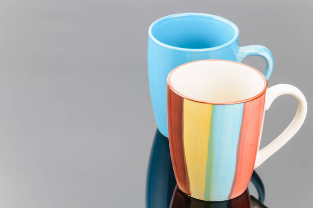 istock Two coffee tea porcelain clay mugs on the grey mirror background. Copy space.  