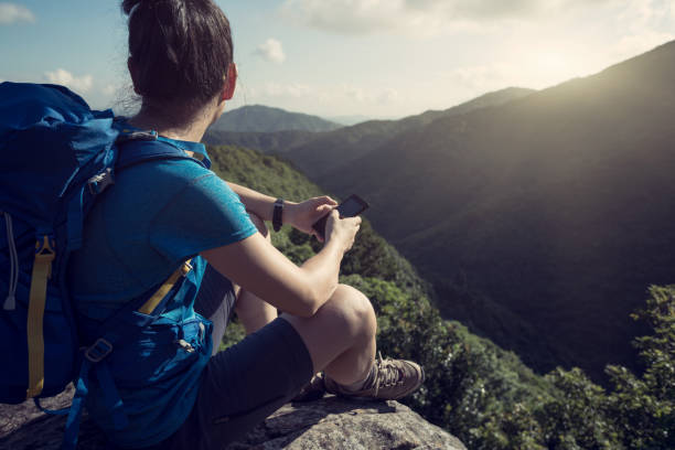 istock Successful woman hiker using smartphone on hiking travel 1016740752