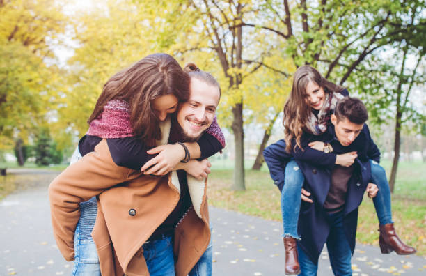 istock Two friend couples having fun in a park 1016741292