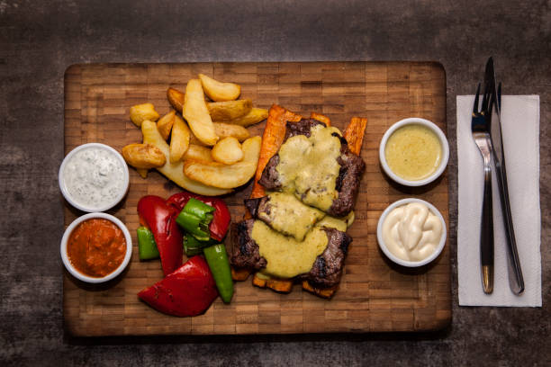 istock Sliced steak Ribeye and cheddar cheese on wood plate. 1016748770