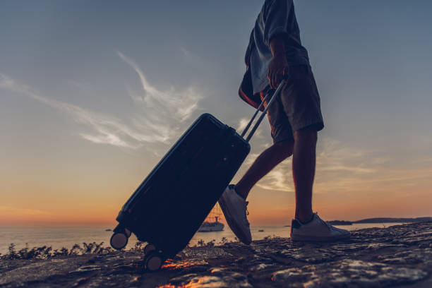 istock Tourist walking by the sea in sunset 1016748842