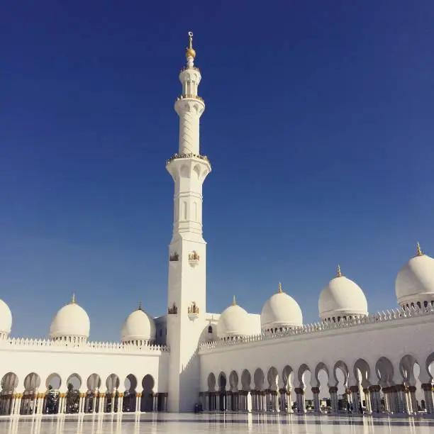 sheikh zayed grand mosque abu dhabi. open courtyard. blue sky.