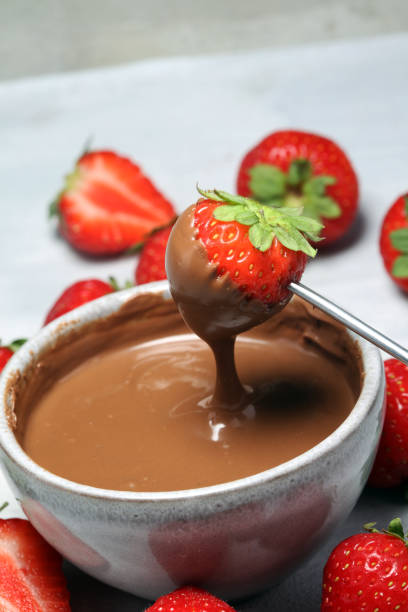 istock Fondue with Melting chocolate or melted chocolate and strawberry. 1016753620
