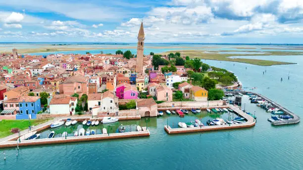 Aerial view of colorful Burano island in Venetian lagoon sea from above, Italy