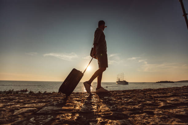 istock Man walking by the sea 1016761650