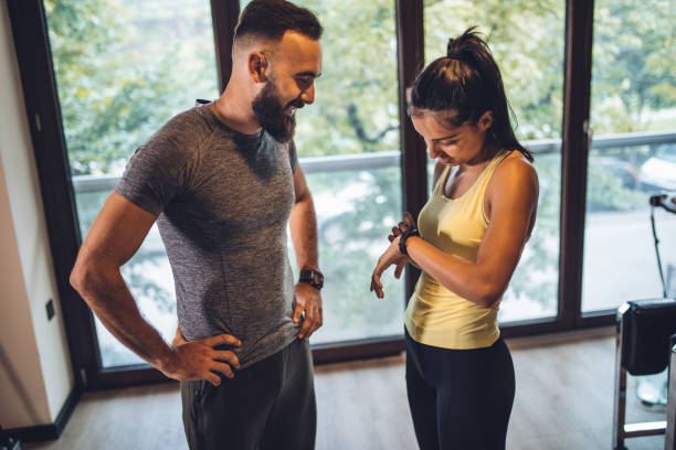 istock Healthy couple exercising in gym together 1016764008