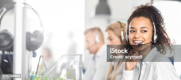 Call Center Worker Accompanied By Her Team Stock Photo - Download Image Now - Service, Customer Service Representative, Customer