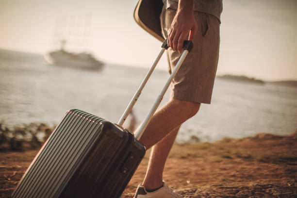 istock Tourist with suitcase by the sea 1016769048
