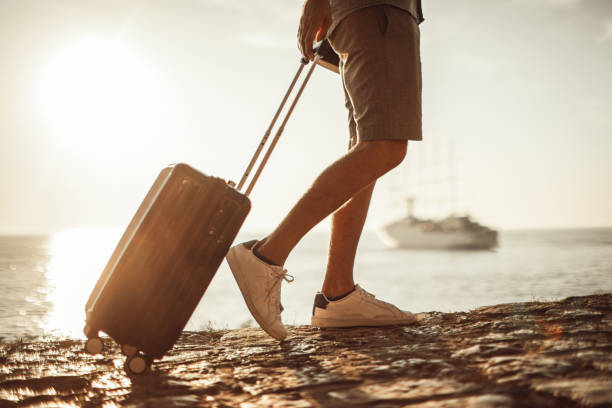 istock Tourist walking by the sea 1016769126