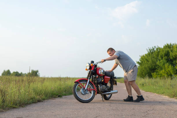 istock A man stands near motorcycle on a clear summer day 1016771592
