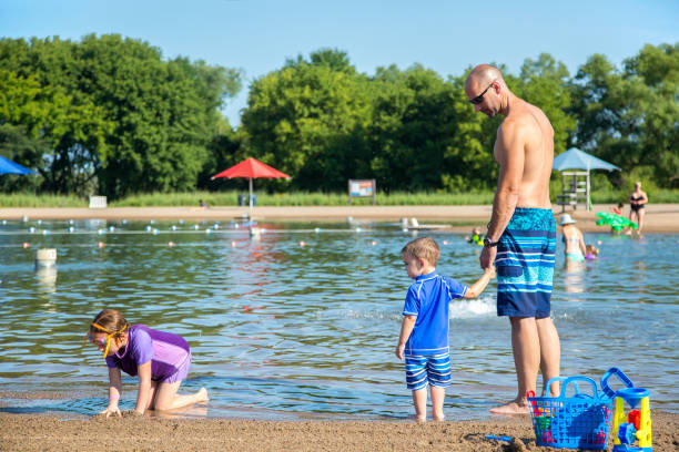 istock Family Playing at Beach on Summer Day 1016779878