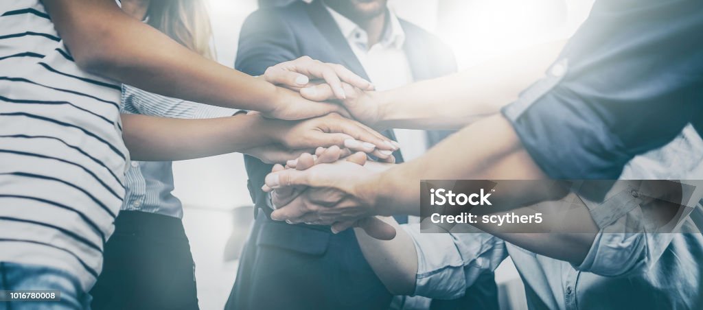Stack of hands. Unity and teamwork concept. Close up view of young business people putting their hands together. Stack of hands. Unity and teamwork concept. Teamwork Stock Photo