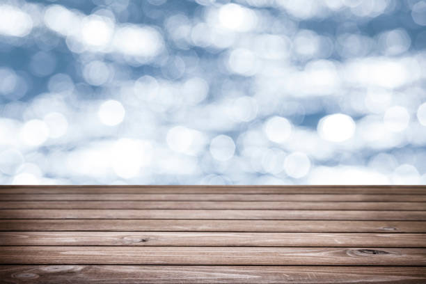 istock Empty rustic wooden table with defocused sea water at background 1016780082