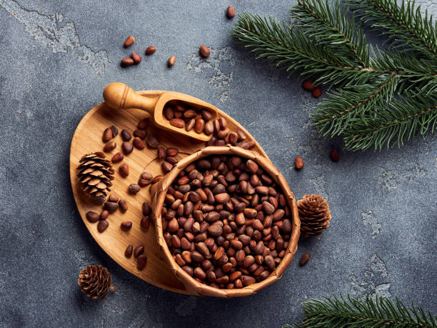 istock Pine nuts in bowl on gray stone table. Top view. 1016780536