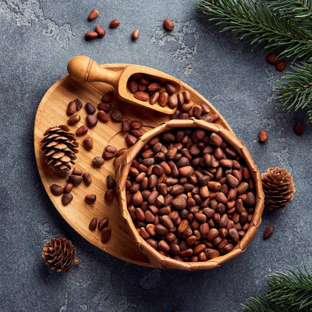istock Pine nuts in bowl on gray stone table. Top view. 1016782968