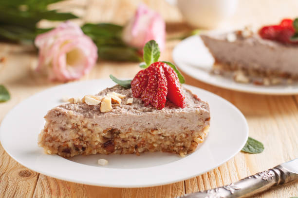 raw vegan cheesecake with strawberry and banana - cheesecake syrup almond cream imagens e fotografias de stock