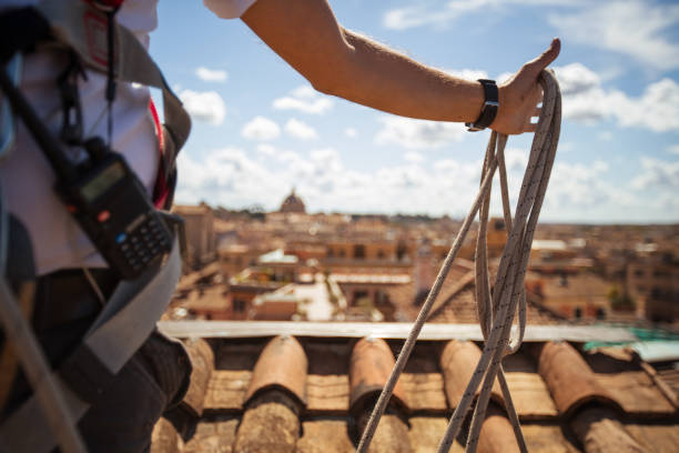 istock Manual workers in action on the roofs of Rome 1016788092
