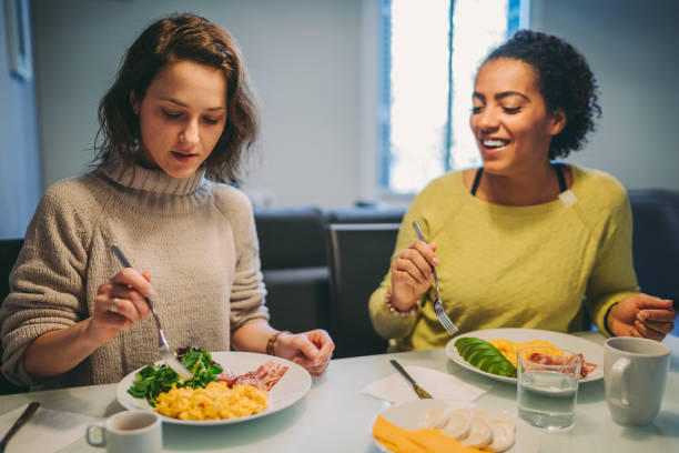 Women eating breakfast at home Two friends enjoying breakfast at home ketogenic diet photos stock pictures, royalty-free photos & images