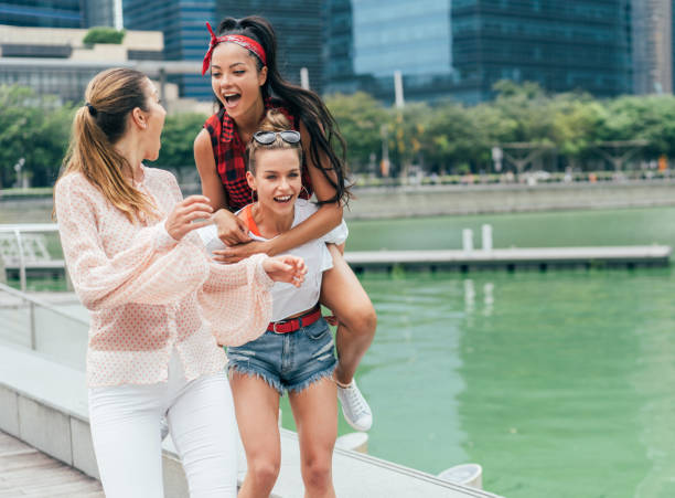 istock Female friends piggyback 1016793808