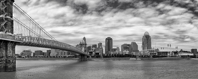 Black and White Stitched Panorama of Statue of Liberty and Manhattan Lower East Side Financial District, Brooklyn Bridge, World Trade Center and Blue Sky with Clouds Reflected in Water of East River, New York, USA. Canon EOS 6D (Full Frame censor) DSLR and Canon EF 24-105mm f/4L lens. 3:1 Image Aspect Ratio.