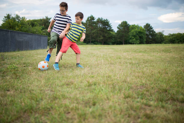 istock Little boys playing football 1016807286