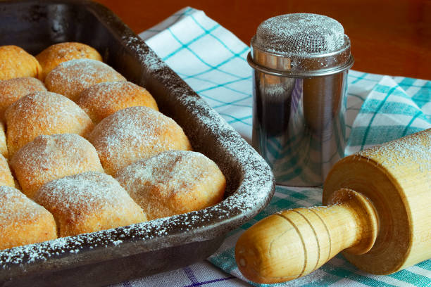 istock sugared poppy and plum cakes on baking tray with sugar bowl and rolling pin 1016818968