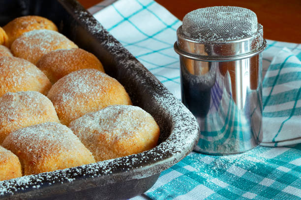 istock sugared poppy and plum cakes on baking tray with sugar bowl and rolling pin 1016822554