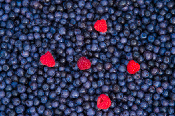 istock mix of raspberries, blueberry textured. top view with copy space 1016864348