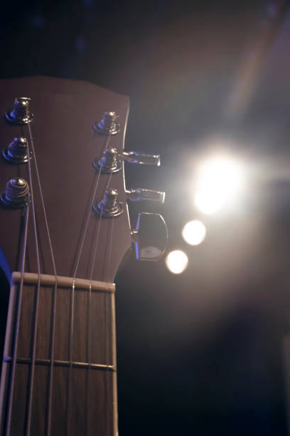 istock acoustic guitar on a wooden background.grain and noise effect 1016870346