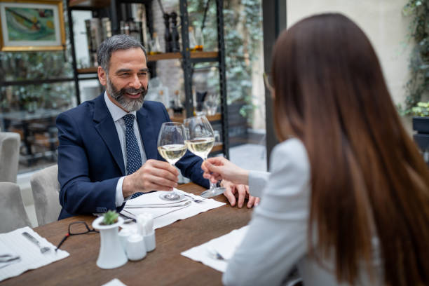 istock Business couple drinking wine at luxury restaurant. 1016872478