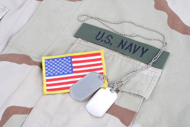 istock US NAVY branch tape with dog tags and flag patch on desert camouflage uniform 1016877384