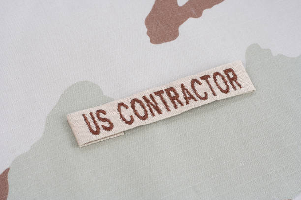 istock US CONTRACTOR branch tape on desert camouflage uniform 1016877424