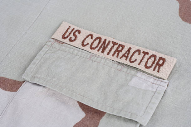 istock US CONTRACTOR branch tape on desert camouflage uniform 1016882078