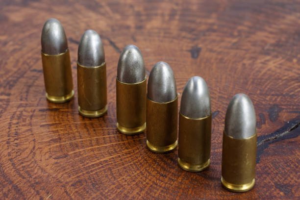 istock 9mm caliber cartridges on wooden background 1016884866