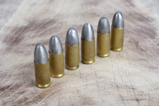 istock 9mm caliber cartridges on wooden background 1016884868