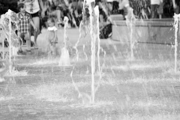 istock Rainbow reflected on the water fountain on a sunny day. Black and white. 1016884892