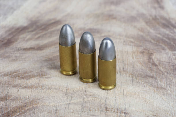 istock 9mm caliber cartridges on wooden background 1016884912