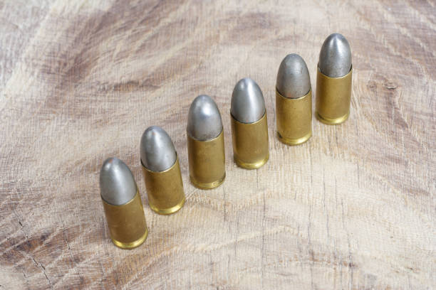 istock 9mm caliber cartridges on wooden background 1016884926